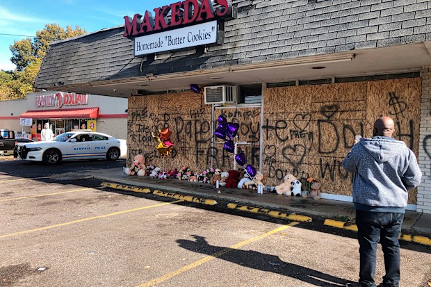 A memorial to slain rapper Young Dolph sits in front of boarded windows at Makeda's Cookies on Thursday, Nov. 18, 2021