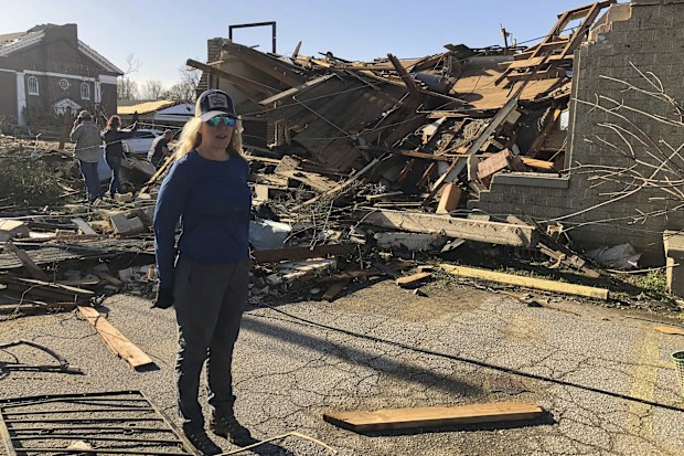 Heidi Jenkins, owner of Boulevard Salon, speaks with a reporter in front of her destroyed business in Wynne, Ark., on Saturday, April 1, 2023. 