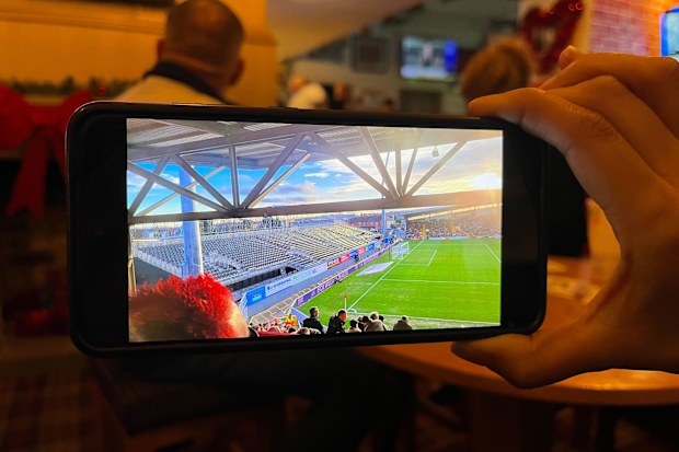 Fans show photos of inside the Wrexham FC stadium and the new temporary stands ahead of a permanent new stand being built