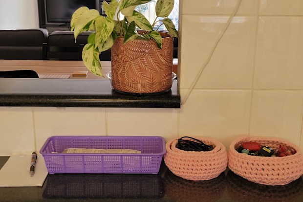 A simple basket helps organise receipts on the kitchen bench entryway.