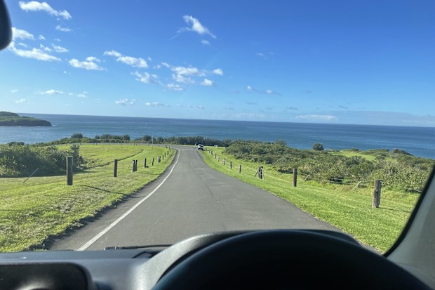 A view out the windscreen on a sunny day, looking at the ocean