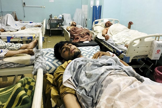 Wounded Afghans lie on a bed at a hospital after a deadly explosions outside the airport in Kabul, Afghanistan, Thursday, Aug. 26, 2021. Two suicide bombers and gunmen attacked crowds of Afghans flocking to Kabul's airport Thursday, transforming a scene of desperation into one of horror in the waning days of an airlift for those fleeing the Taliban takeover. The attacks killed at least 60 Afghans and 12 U.S. troops, Afghan and U.S. officials said. (AP Photo/Mohammad Asif Khan)