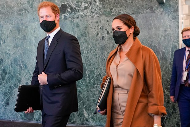 Prince Harry and Meghan, the Duke and Duchess of Sussex are escorted as they leave the United Nations headquarters after a visit during 76th session of the United Nations General Assembly, Saturday, Sept. 25, 2021. (AP Photo/Mary Altaffer)