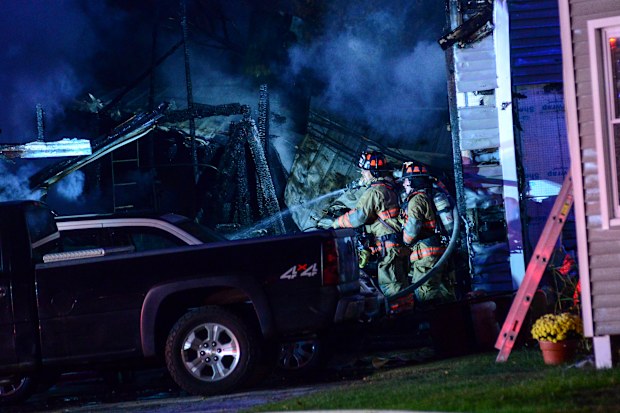 Firefighters work after a single-engine plane crashed Friday, Oct. 21, 2022, in Keene, N.H.  