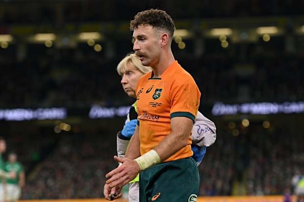 Nic White of Australia leaves the pitch for a head injury assessment.