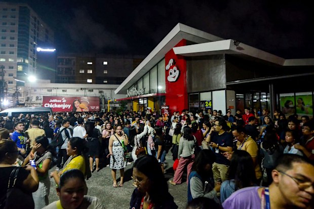 People gather on a street after earthquake tremors at Cebu in central Philippines on September 30.