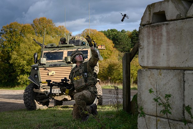 A British soldier launches a DefendTex D40 under-slung grenade launcher drone during a training exercise.