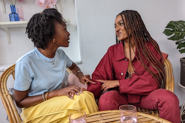 Female friends talking at a table.