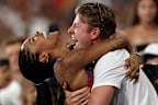 PARIS, FRANCE - AUGUST 08: Tara Davis-Woodhall of Team United States celebrates with her husband Hunter Woodhall after winning the gold medal in the Women's Long Jump Final on day thirteen of the Olympic Games Paris 2024 at Stade de France on August 08, 2024 in Paris, France. (Photo by Patrick Smith/Getty Images)