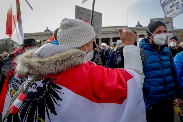 People take part in a demonstration against the country's coronavirus restrictions in Vienna, Austria