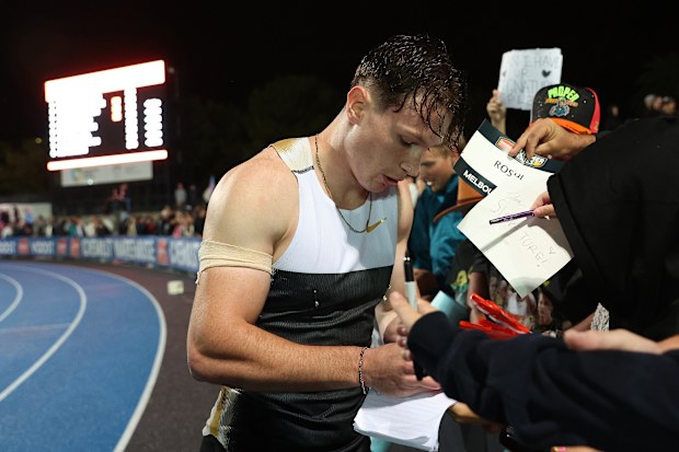 MELBOURNE, AUSTRALIA - MARCH 28:  Lachlan Kennedy signs autographs following the Men's 200m during the 2026 Maurie Plant Meet at Lakeside Stadium on March 28, 2026 in Melbourne, Australia. (Photo by Kelly Defina/Getty Images)