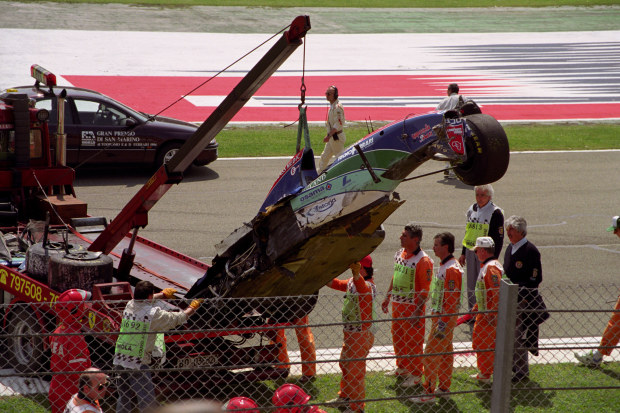 The crashed car of Rubens Barrichello is cleared from the track during Friday qualifying for the 1994 San Marino Grand Prix.  (Photo by Steve Etherington/EMPICS via Getty Images)