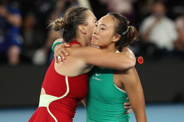 MELBOURNE, AUSTRALIA - JANUARY 27: Aryna Sabalenka and Qinwen Zheng of China embrace at the net after their Women's Singles Final match during the 2024 Australian Open at Melbourne Park on January 27, 2024 in Melbourne, Australia. (Photo by Darrian Traynor/Getty Images)