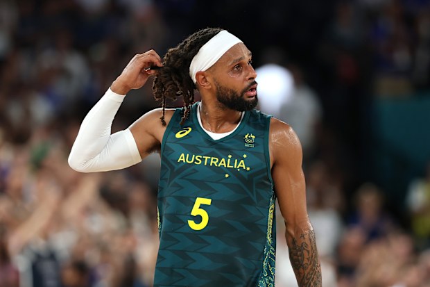 Patty Mills of Australia reacts.