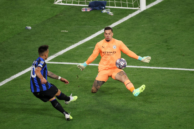 Ederson of Manchester City makes a save from Lautaro Martinez.