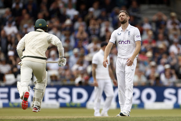Chris Woakes reacts after Joe Root drops a catch.