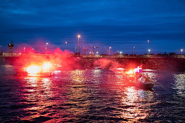 French fishermen light flares as they block the entrance to the port of Saint-Malo, western France, Friday, Nov. 26, 2021. 
