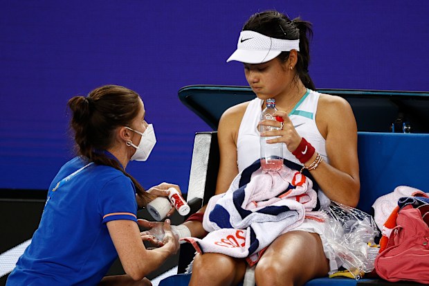 Emma Raducanu receives attention during a medical time out in her second round singles match against Danika Kovinic.
