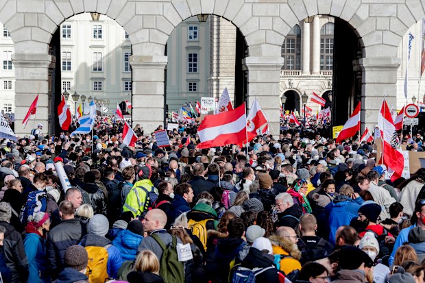 People take part in a demonstration against the country's coronavirus restrictions in Vienna, Austria