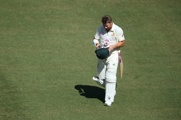 David Warner of Australia walks off the field after been dismissed by Ravichandran Ashwin of India.