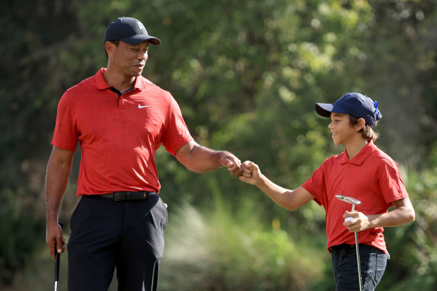 Tiger Woods and Charlie Woods celebrate a birdie on the 12th hole during the final round of the PNC Championship.
