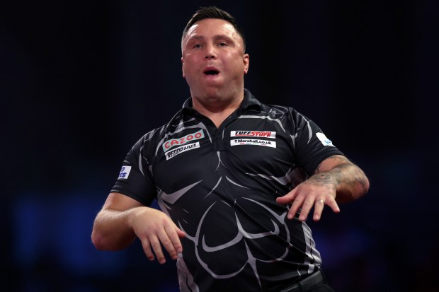 Gerwyn Price reacts after missing a triple 20 during his fourth round match against Jose de Sousa during the World Darts Championship.