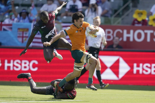 Australia's Henry Paterson evades the Kenyan defence to score a try.