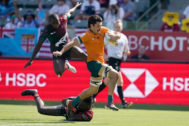 Australia's Henry Paterson evades the Kenyan defence to score a try.