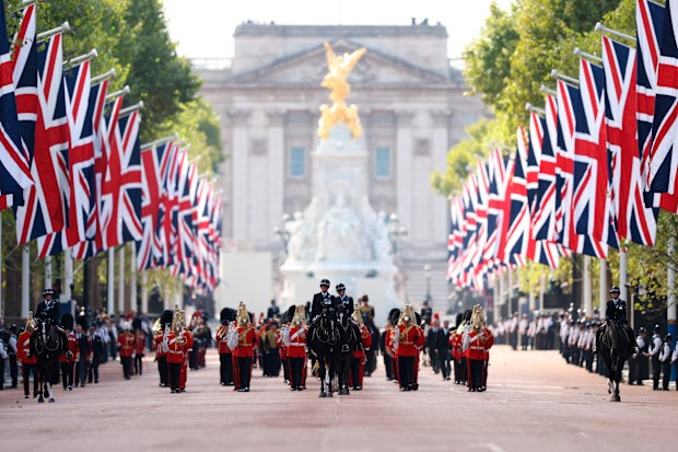 Members of the armed move the coffin of Queen Elizabeth II, adorned with a Royal Standard and the Imperial State Crown, during a procession from Buckingham Palace to Westminster Hall in London, Wednesday, Sept. 14, 2022. The Queen will lie in state in Westminster Hall for four full days before her funeral on Monday Sept. 19. (Cameron Eden/Ministry of Defense via AP)