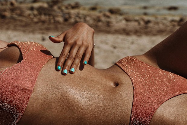 Stock photo of a woman in a bikini at the beach.