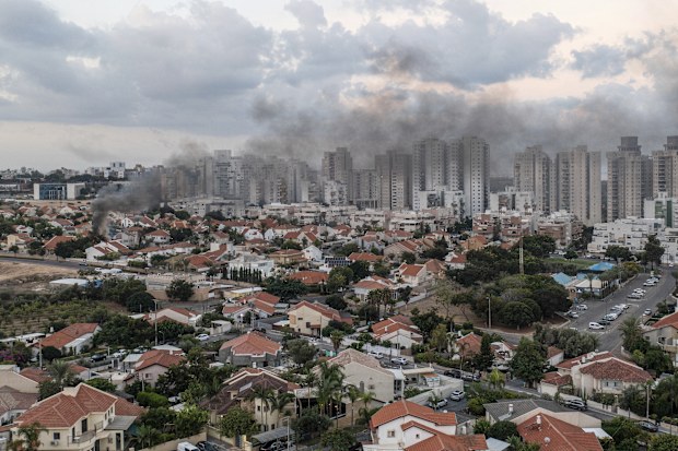 Smoke rises after a rocket fired from the Gaza Strip hit a house in Ashkelon, southern Israel, Saturday, Oct. 7, 2023.  