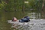 Connor Hughes of Lithia, Fla., moves in deep floodwaters from Hurricane Milton along the Alafia river Friday, Oct. 11, 2024, in Lithia, Fla.