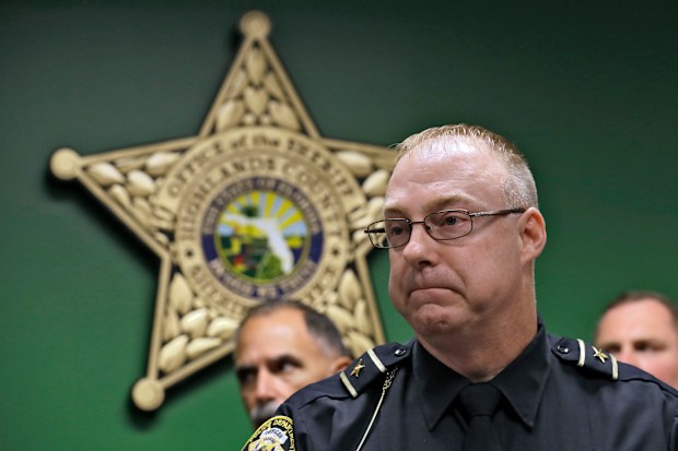 Sebring Police Chief Karl Hoglund reacts as he listens to a question during a news conference
