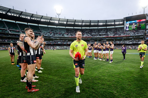 MELBOURNE, AUSTRALIA - JULY 15: AFL Field Umpire, Brett Rosebury receives a guard of honour for his 500th game during the 2023 AFL Round 18 match between the Collingwood Magpies and the Fremantle Dockers at the Melbourne Cricket Ground on July 15, 2023 in Melbourne, Australia. (Photo by Dylan Burns/AFL Photos via Getty Images)