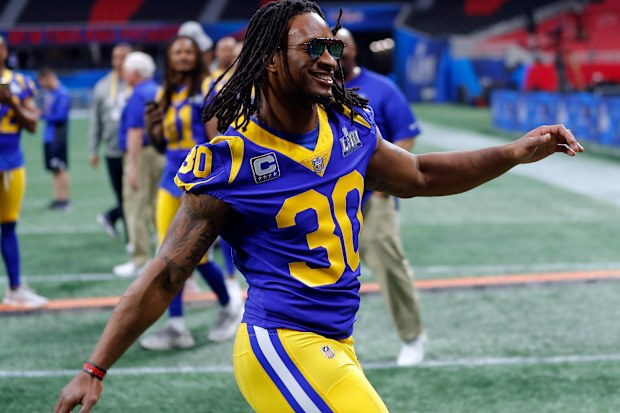 Los Angeles Rams running back Todd Gurley (30) rushes to join teammates for a photograph during walkthrough at the Mercedes Benz Stadium for the NFL Super Bowl 53.