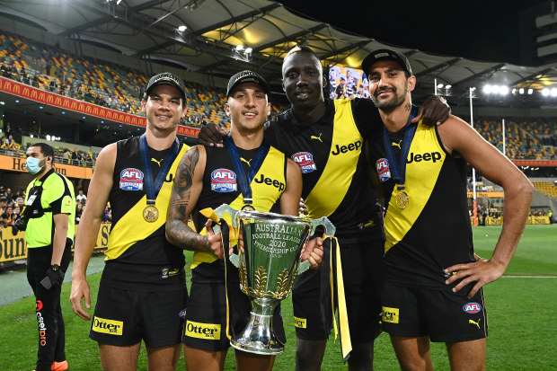 BRISBANE, AUSTRALIA - OCTOBER 24: Daniel Rioli, Shai Bolton, Mabior Chol and Marlion Pickett of the Tigers celebrate with the Premiership Trophy during the 2020 AFL Grand Final match between the Richmond Tigers and the Geelong Cats at The Gabba on October 24, 2020 in Brisbane, Australia. (Photo by Quinn Rooney/Getty Images)