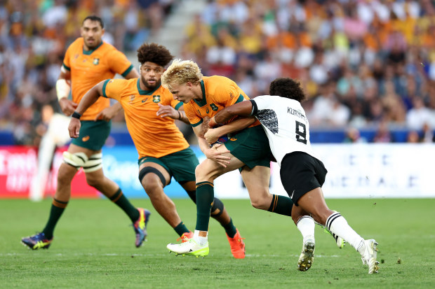 Carter Gordon of Australia is tackled by Simione Kuruvoli of Fiji.