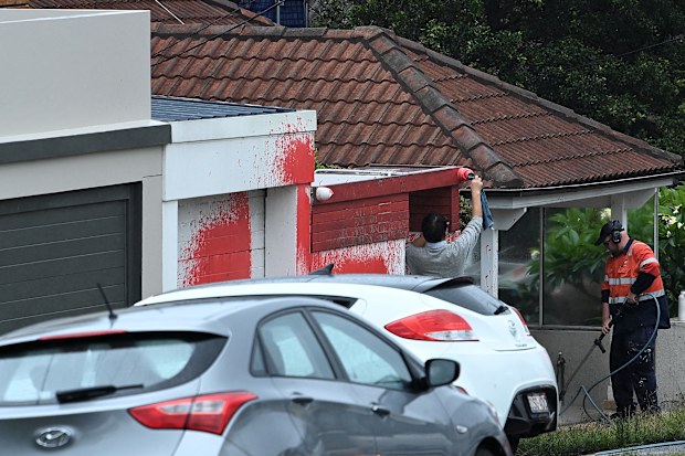 A man removes paint from a security camera from a home on Military Road at the scene of an antisemitic attack in Dover Heights NSW. January 17, 2025.