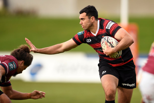 Jack Debreczeni of Canterbury attempts to fend off Isaac Te Tamaki of Southland.