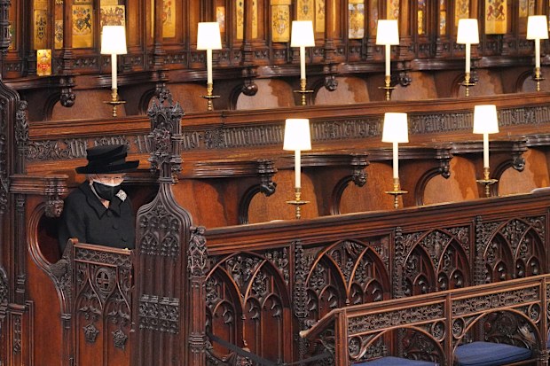 (EDIT) Queen Elizabeth II takes her seat during the funeral of Prince Philip, Duke of Edinburgh in St George's Chapel at Windsor Castle on April 17, 2021 in Windsor, England. Prince Philip  married the then Princess Elizabeth on 20 November 1947. He served as Prince Consort to Queen Elizabeth II until his death on April 9 2021, months short of his 100th birthday. only 30 guests invited due to Coronavirus pandemic restrictions. 