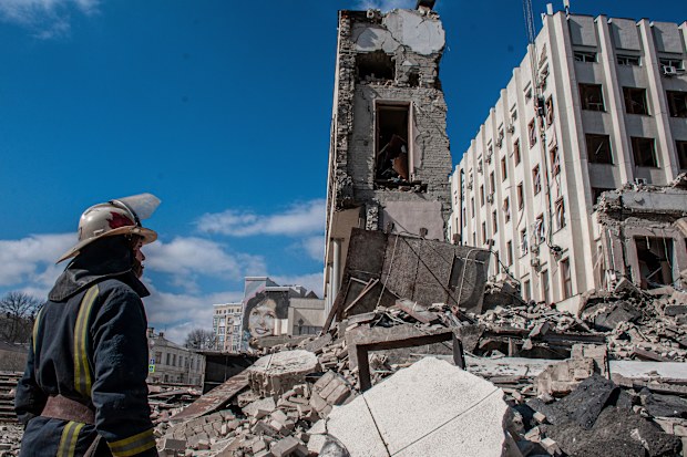 Rescuers work at the site of the National Academy of State Administration building damaged by shelling in Kharkiv, Ukraine, March 18, 2022 