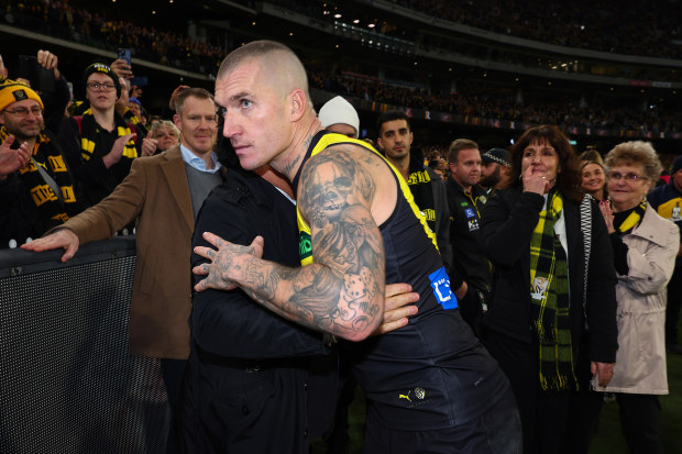 Dustin Martin of the Tigers embraces his agent Ralph Carr following his 300th match.