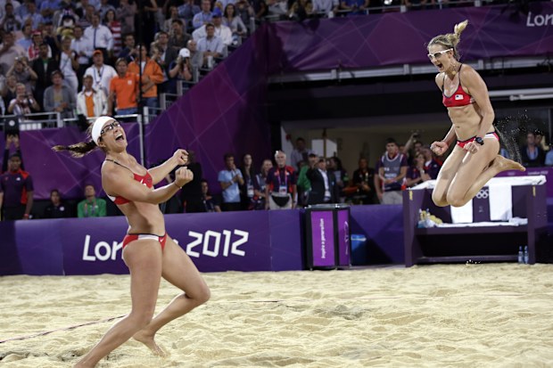 Miss May Treanor, left, and Kerri Walsh Jennings celebrate a win over April Ross and Jennifer Kessy during the women's Gold Medal beach volleyball match between two United States teams at the 2012 Summer Olympics, Wednesday, Aug. 8, 2012, in London.