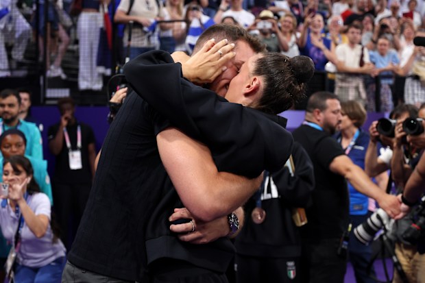 Bronze medalist Alessia Maurelli of Team Italy celebrates with Massimo Bertelloni after being proposed to after the Rhythmic Gymnastics Group All-Around Final 