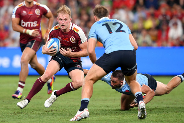 Tom Lynagh looks to take on the defence during the Super Rugby Pacific match between Queensland Reds and NSW Waratahs.