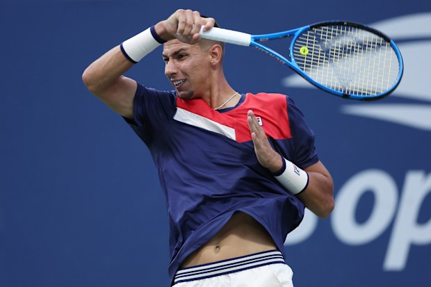 Alexei Popyrin of Australia returns a shot against Dominic Stricker of Switzerland.