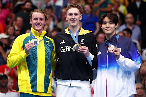 Australian silver medallist Elijah Winnington, German gold medallist Lukas Märtens and South Korean bronze medallist Kim Woo-min pictured after the men's 400m freestyle final at Paris 2024.