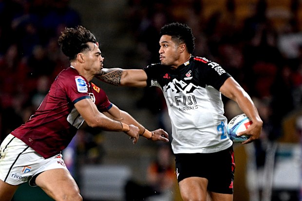 Leicester Fainga'anuku of the Crusaders takes on the defence of Jordan Petaia of the Reds.