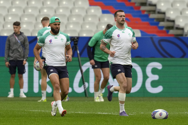 Ireland's Jamison Gibson-Park, left, with teammate Mack Hansen practice during their stadium run training session at the Stade de France.