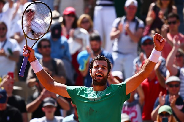 Karen Khachanov celebrates winning match point against Thanasi Kokkinakis of Australia.